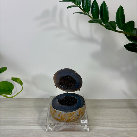 Druzy mermaid box featuring a split geode with a sparkling black crystal interior and a textured, tan-colored exterior.