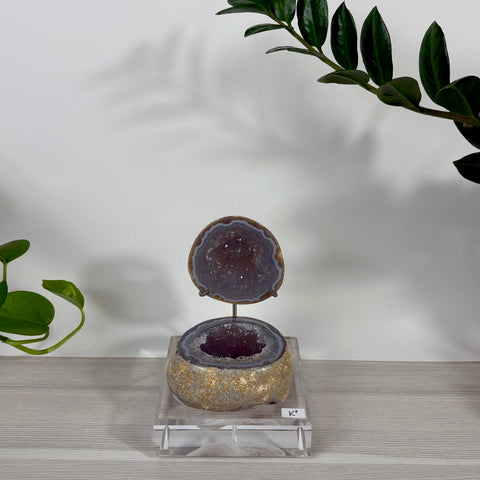 Druzy mermaid box with purple amethyst geode, gold leaf exterior, and a hinged lid on a clear acrylic display stand.
