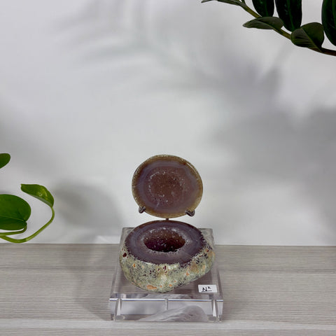 Druzy mermaid box featuring a purple geode stone container with a matching lid on a clear acrylic display stand.