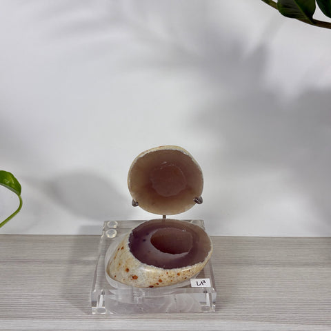Druzy mermaid box in brown agate with a sparkling crystal interior, displayed on a clear acrylic stand labeled U2.