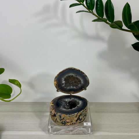 Druzy mermaid box made from a natural agate geode with sparkling crystal interior on a clear acrylic stand.