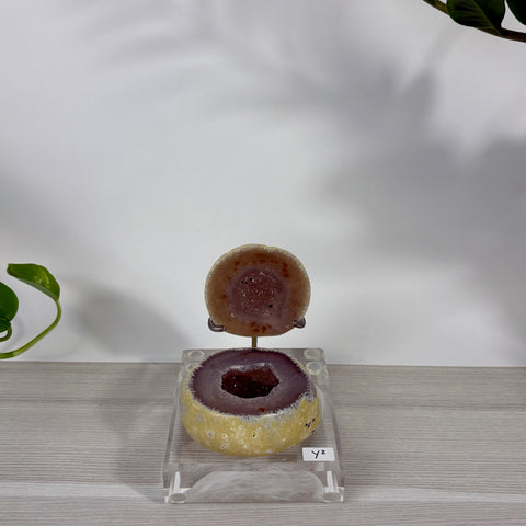 Druzy mermaid box with a purple geode center and yellow outer shell, displayed on a clear acrylic stand.