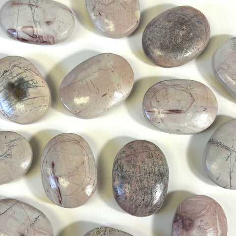 Smooth, polished pink and grey Imperfect Painting Stone palm stones with natural striations.