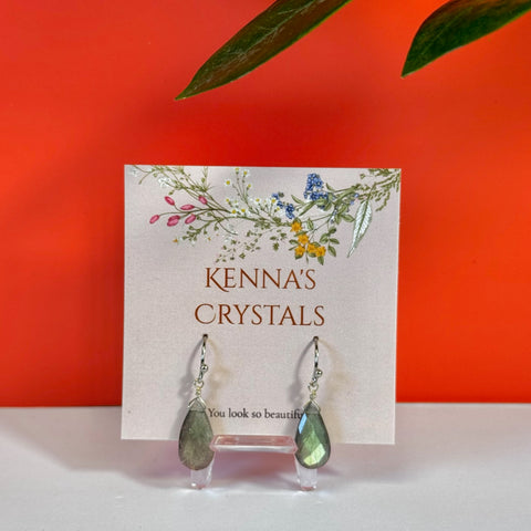 Teardrop labradorite earrings with silver hooks on a floral Kenna's Crystals display card.