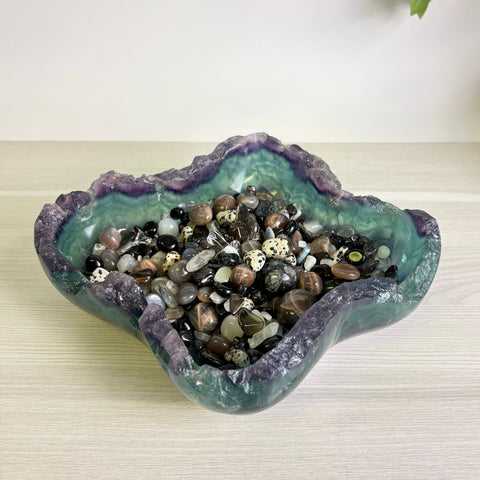 Mystic Mountain bowl carved from purple and green fluorite filled with a variety of polished gemstone crystals.