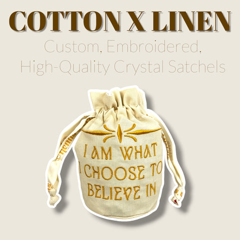 Natural cotton and linen drawstring crystal pouch with gold embroidery and ruffled top.