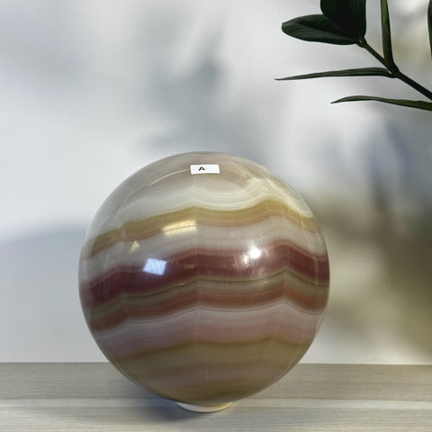 XL pink banded onyx sphere with natural white, cream, and reddish-pink horizontal bands.