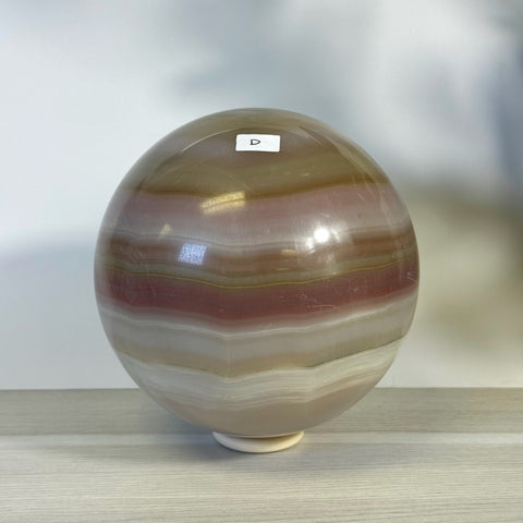 XL pink banded onyx sphere with natural brown, white, and pink horizontal bands.