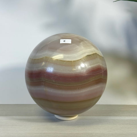 XL pink banded onyx sphere with natural white and brown layers, labeled "E".