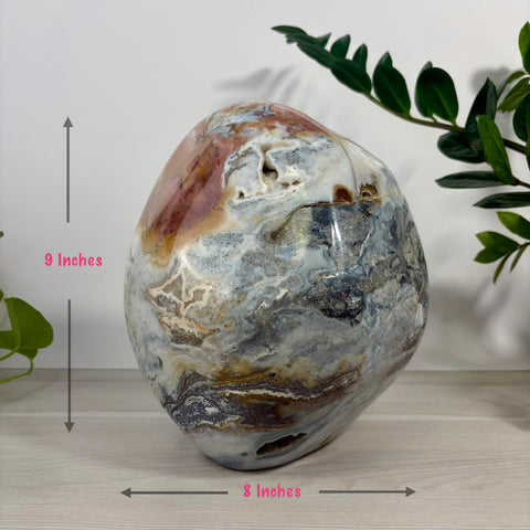 Polished XL sea jasper free form stone with swirling grey, white, and red patterns, measuring 9 by 8 inches.