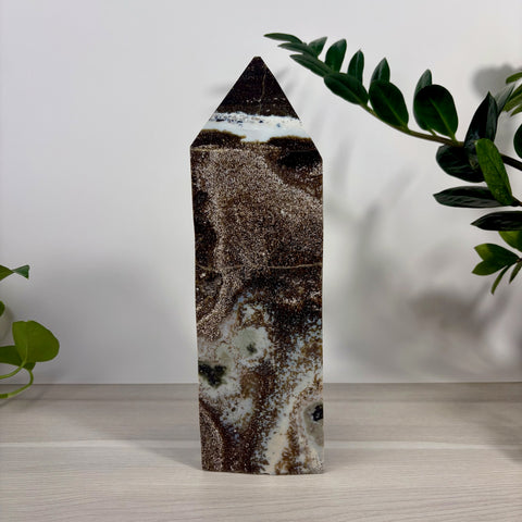 XXXL Sea Jasper tower featuring a polished obelisk shape with swirling patterns of deep brown, cream, and speckled mineral textures.