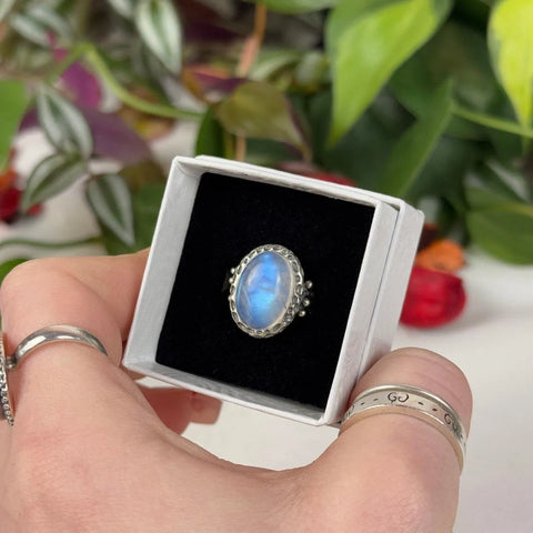 June collection: Sterling silver ring with an oval iridescent moonstone in a white gift box.