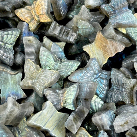 Sparkling labradorite butterfly and star carvings with iridescent blue, green, and gold flashes.