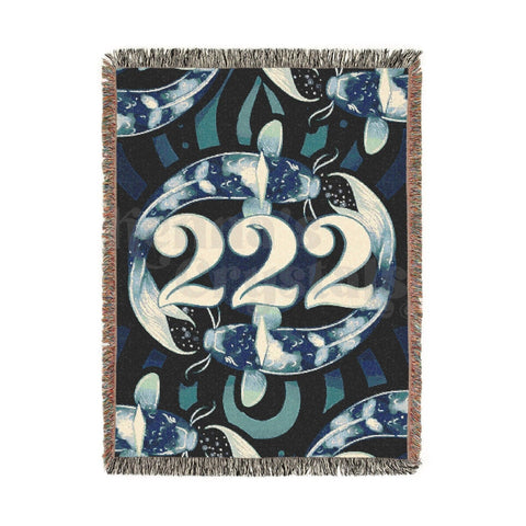 Eco Luxe XL woven blanket with "222" encircled by blue koi fish on a dark, patterned background.