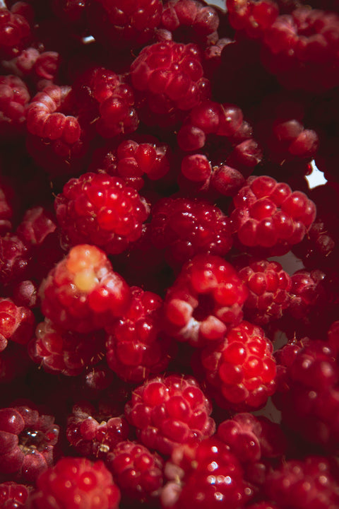 Vibrant, fresh red raspberries, evoking a sweet, rosy, and romantic aesthetic.