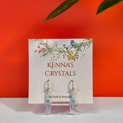 Blue Topaz & Blue Zircon earrings on a "Kenna's Crystals" card, featuring clear crystal drops.