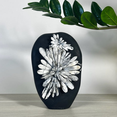 Black chrysanthemum stone free form with white floral patterns.