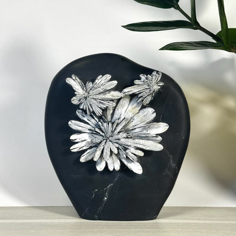 Black chrysanthemum stone free form with white floral patterns.