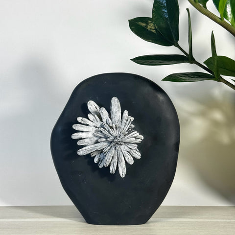 Black chrysanthemum stone free form with white crystal flower pattern.