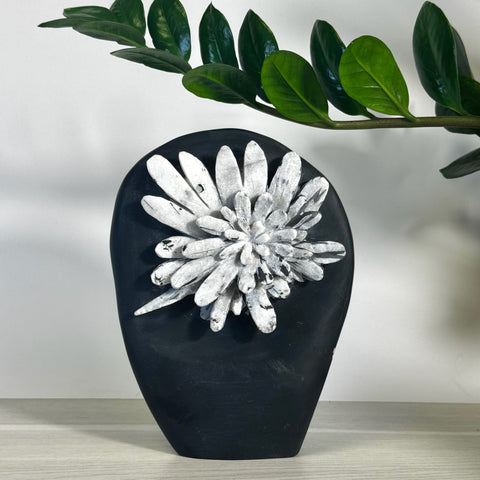 Black chrysanthemum stone free form with white floral crystal formation.