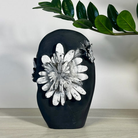 Black chrysanthemum stone free form with white floral patterns.