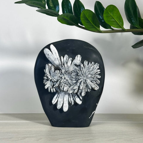 Black chrysanthemum stone free form with white floral patterns, natural and unique.
