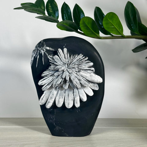 Black chrysanthemum stone free form with white flower-like crystal patterns.