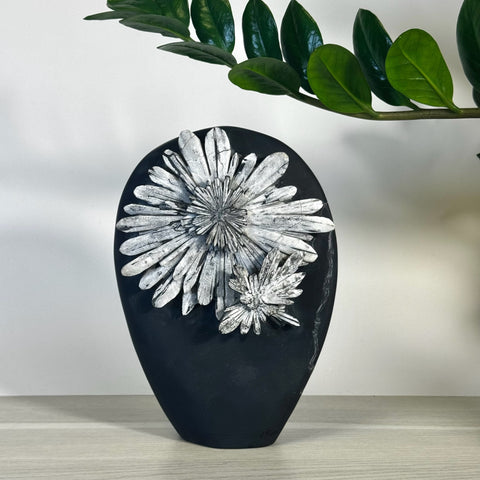 Black chrysanthemum stone free form with white floral patterns.
