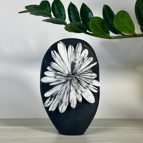 Black chrysanthemum stone free form with white floral pattern.