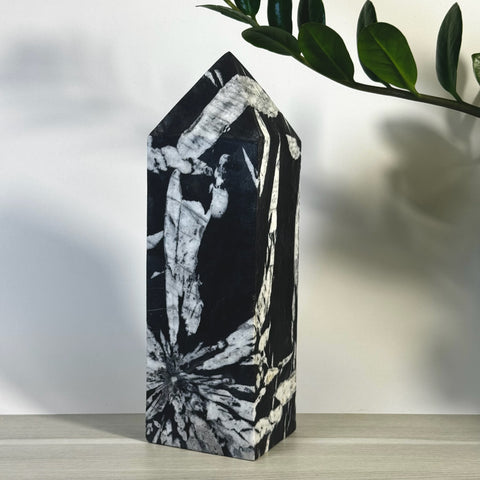 Black and white Chrysanthemum Stone Tower with striking floral patterns, polished finish.