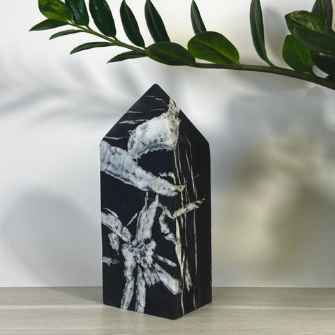 Black and white Chrysanthemum Stone Tower with unique floral patterns, a pointed top, and polished finish.