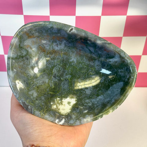 Curvy moss agate bowl, organic shape with deep green, white, and brown patterns, held in a hand.