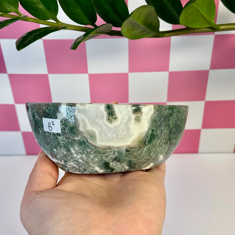 Curvy moss agate bowl, variant B2, held in hand, showing green and white natural patterns.