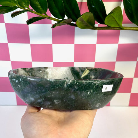 Curvy moss agate bowl, variant E, held in hand, showing deep green and white natural patterns.