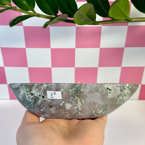 Curvy moss agate bowl, variant E2, held in hand, showing natural green, white, and gray patterns.