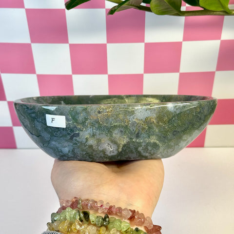 Curvy moss agate bowl, variant F, held in hand, showing natural green and white patterns.