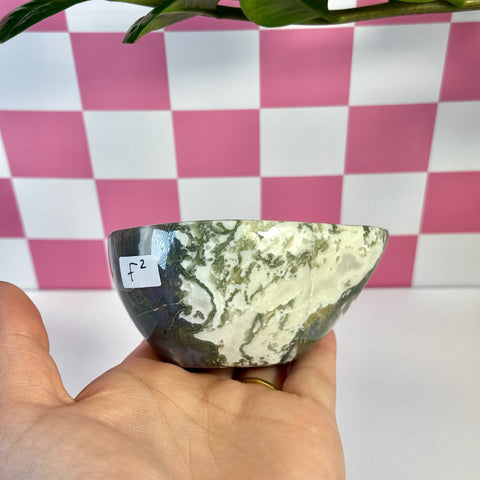 Curvy moss agate bowl, F2 variant, with green and white natural patterns, held in a hand.