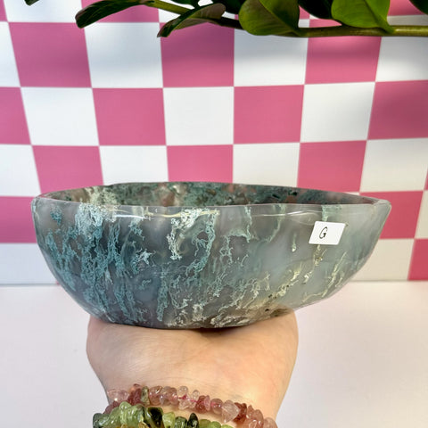 Curvy moss agate bowl, natural green and white patterns, held in hand.