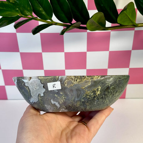 Curvy moss agate bowl, variant R, held in hand, showing green, white, and gray natural patterns.