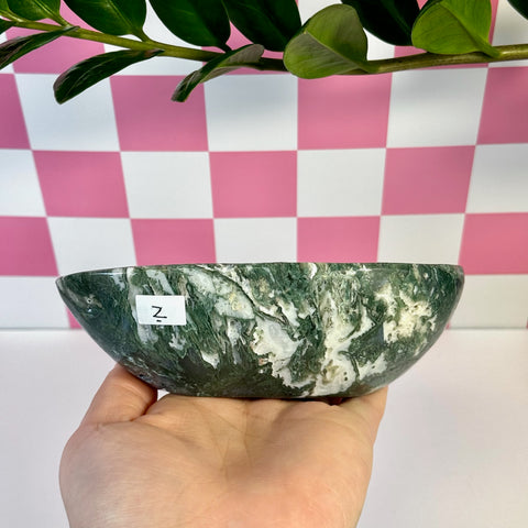Curvy moss agate bowl, dark green and white, held in hand, with a Z label.