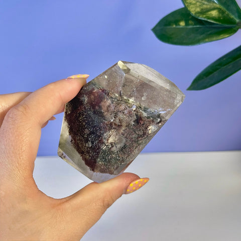 Garden Quartz free form with clear crystal and dark red, green, and black mineral inclusions.
