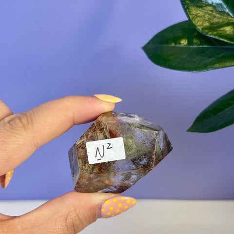 Garden Quartz free form N2, a faceted crystal with earthy green and brown inclusions.