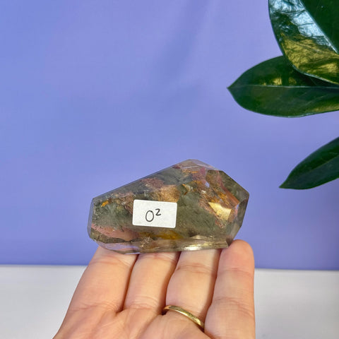 Garden Quartz Free Form, O2 variant, with green, red, and gold inclusions, held in hand.