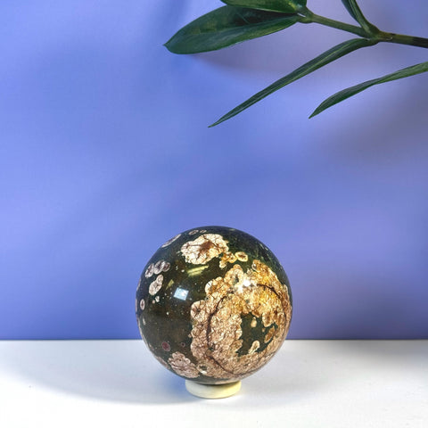 Green Cherry Blossom Sphere with white and brown floral patterns, on a stand.