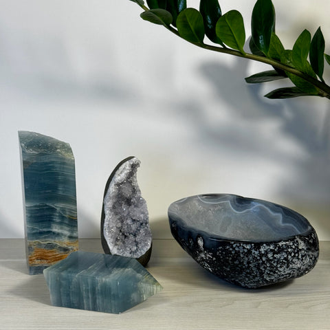 Blue onyx tower, blue fluorite point, geode, and black agate bowl with white speckles.