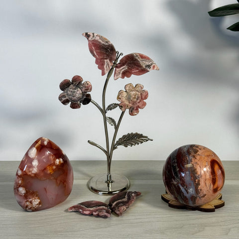 Pink and white agate crystal flower sculpture with two polished crystal eggs and small crystal pieces.