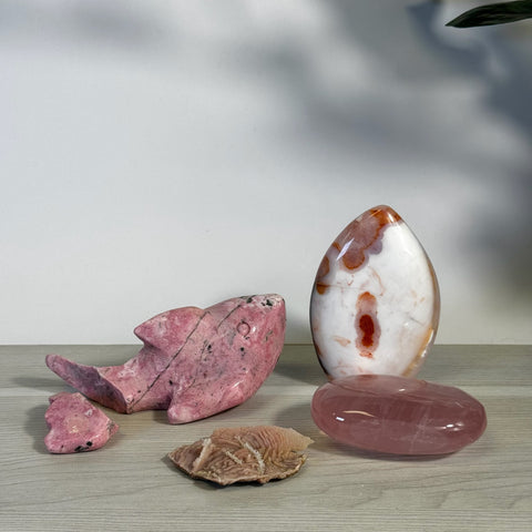 Pink rhodonite shark, rose quartz oval, and white/orange agate crystal bundle.