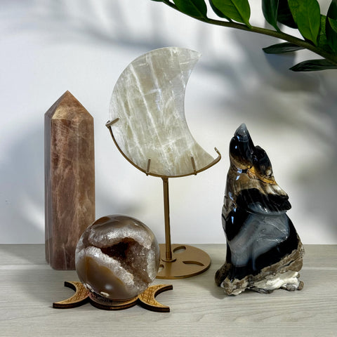 Kenna's Stylized Imperfect Bundle: Moonstone crescent, brown crystal tower, geode sphere, and black agate wolf.