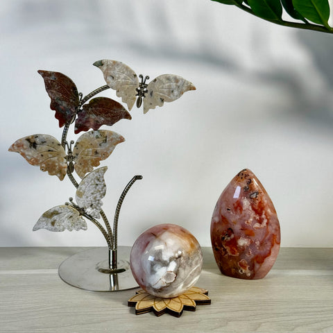 Kenna's Stylized Imperfect Bundle: A collection of polished, natural crystal stones, including a sphere and a teardrop shape, with a butterfly-themed metal stand.