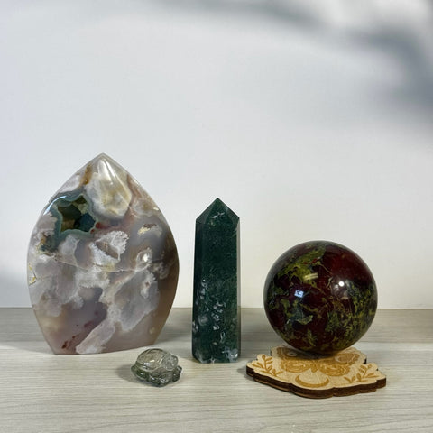 Kenna's Stylized Imperfect Bundle: Agate flame, green crystal tower, dragon's blood jasper sphere on wood stand, and small clear turtle.